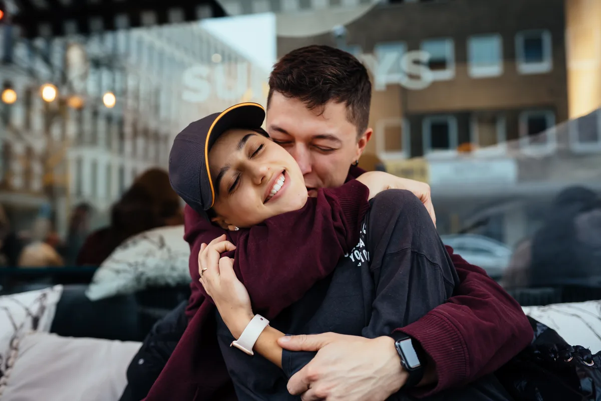 Adult couple sharing an affectionate outdoor moment, editorial imagery for Muslim HSV dating