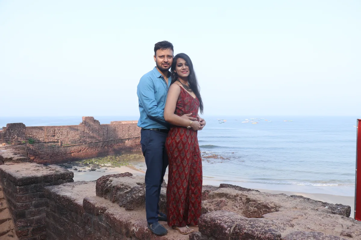 Adult couple embracing beside the coast, illustrating travel and HSV dating by location